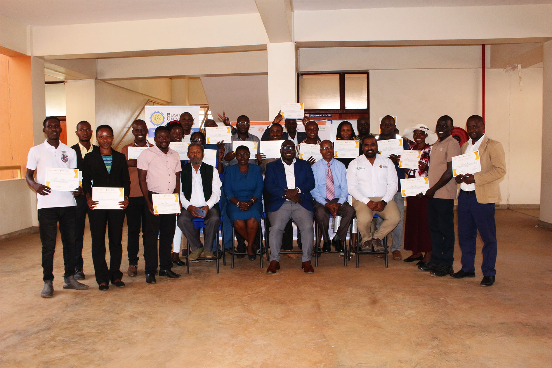 Members of the second cohort pose for a group photo with University Management, a representative of the Ministry of Energy and Mineral Development, and the trainers after completing the advanced solar installation training