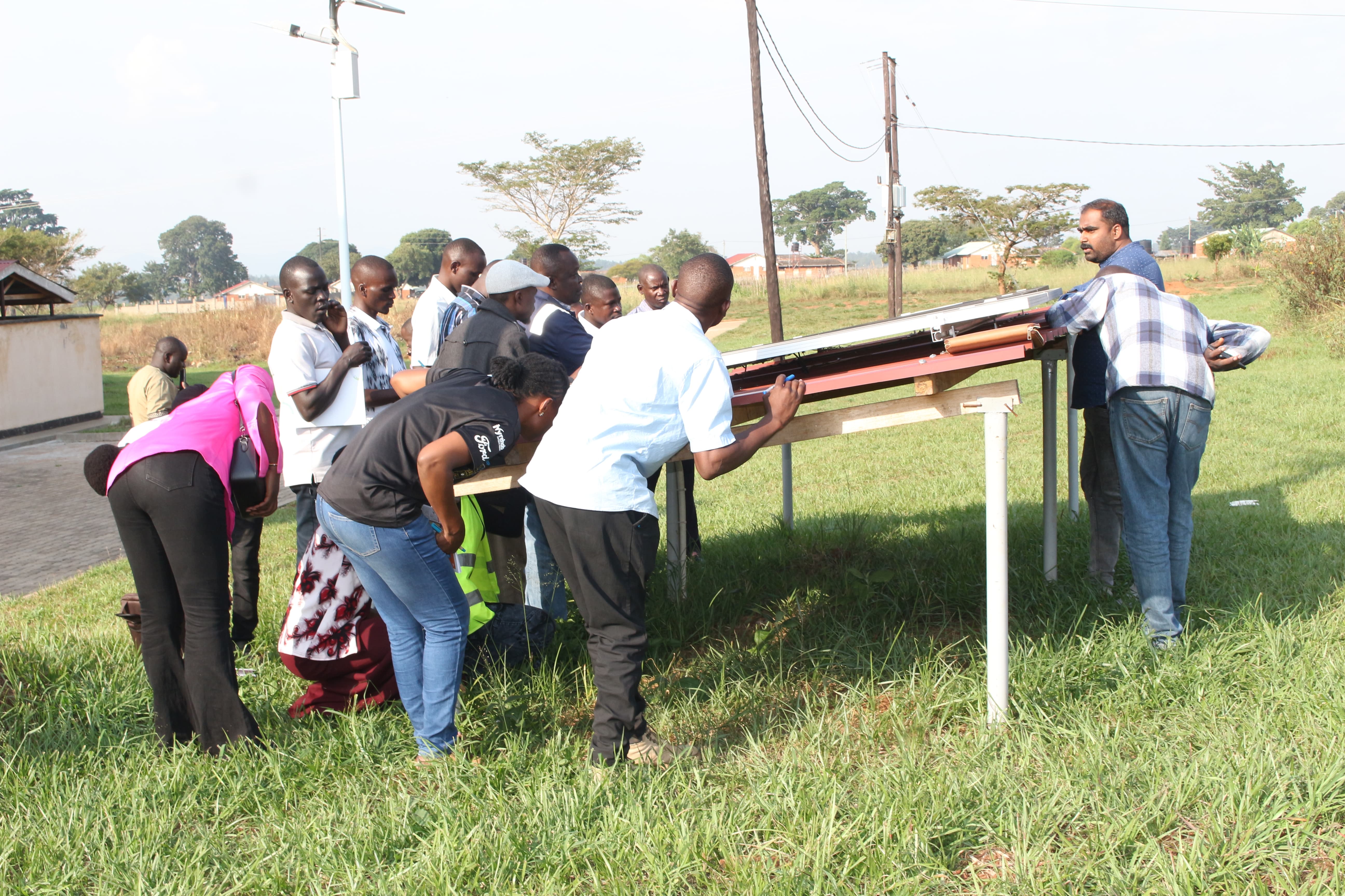 Participants take part in a practical outdoor session on solar installation under the guidance of the trainers